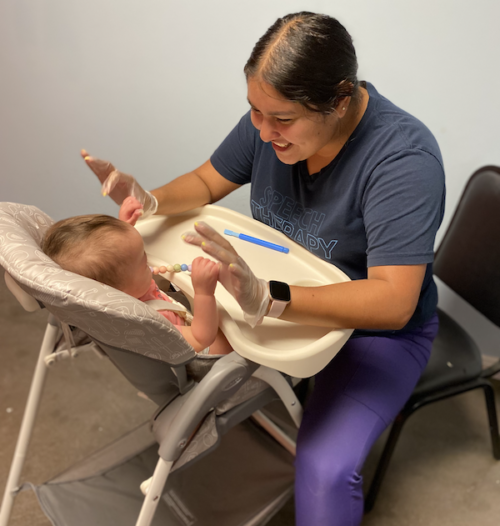 SLP Gabby works on feeding therapy with a baby