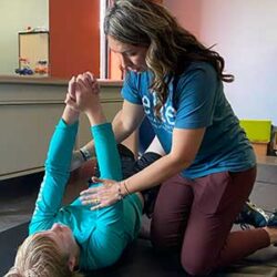 Shae, PT, treats a youth in sports therapy