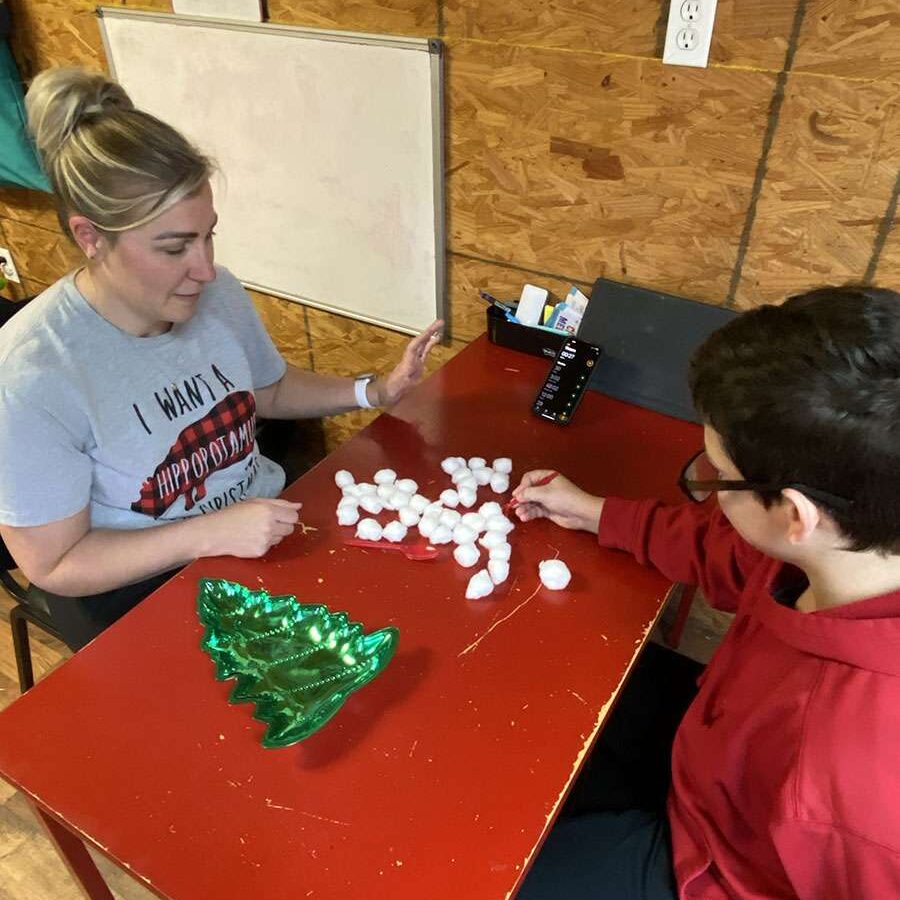 Laurie Maler, SLP, practices a therapeutic game with a teenage student