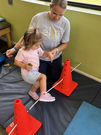 SarahObstacleCourse Sarah Calaway helps child in PT